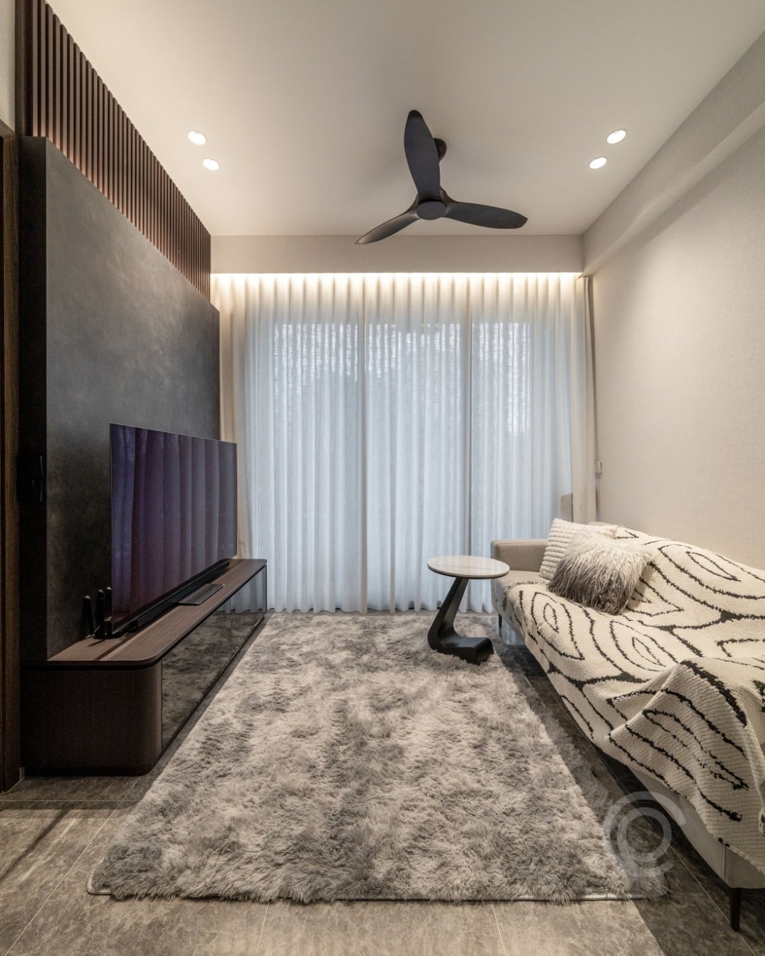 12. Textured Gray Media Accent Wall with Vertical Wood Detail - accent wall ideas for living room