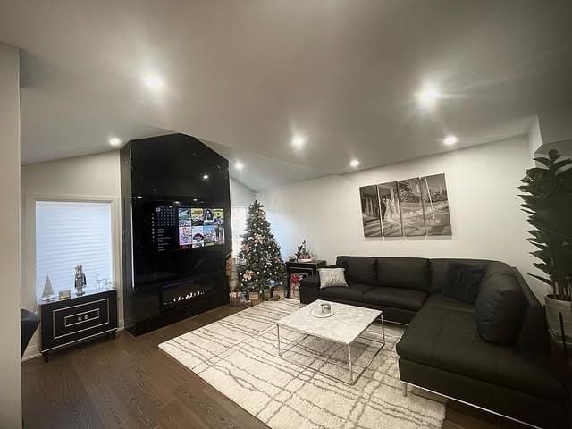 13. Glossy Black Feature Wall with Integrated Fireplace - accent wall ideas for living room