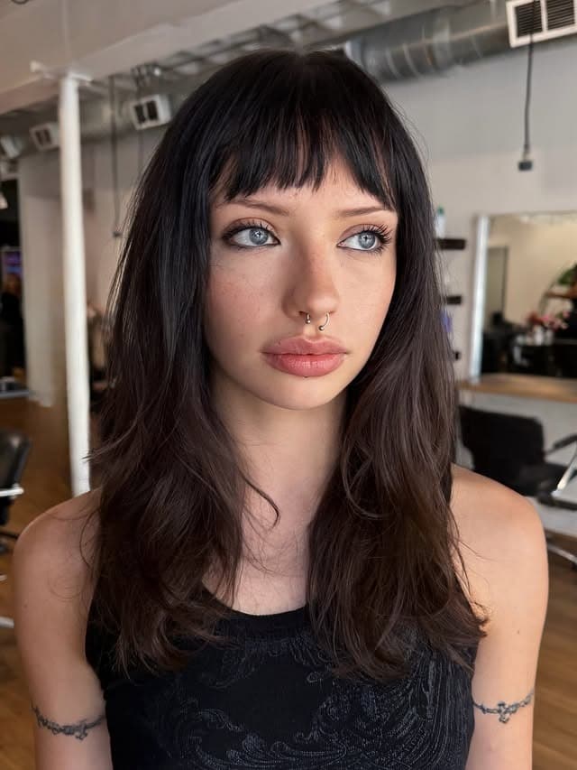 9. Long Shag-Inspired Layers with Choppy Bangs in Dark Mocha - Long Layered Hairstyles with Bangs