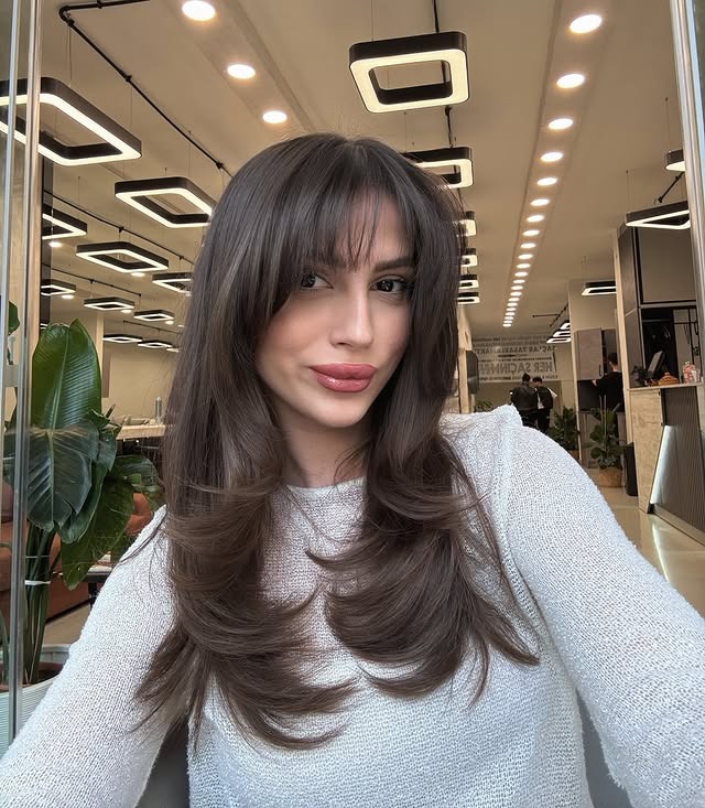 20. Smooth Long Layers with Feathered Bangs in Cool Brown - Long Layered Hairstyles with Bangs