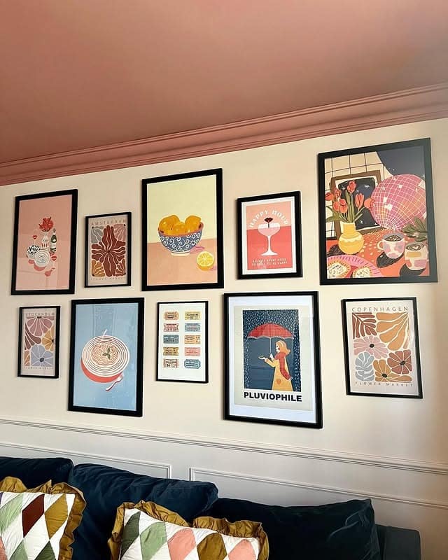 9. Graphic Poster Gallery with Muted Pastels - gallery wall living room ideas