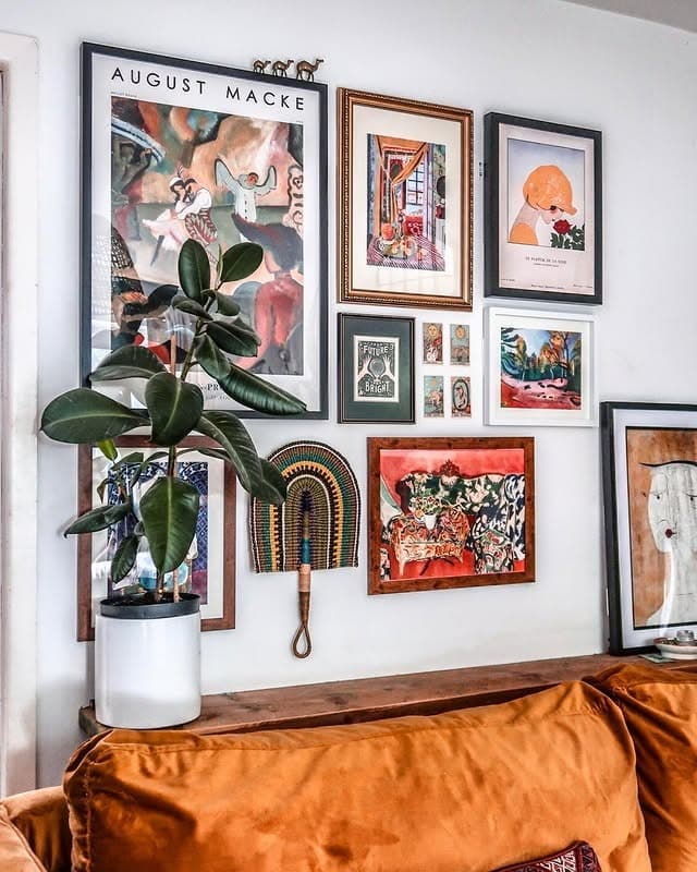 10. Collected Art Wall with Vintage Warmth - gallery wall living room ideas