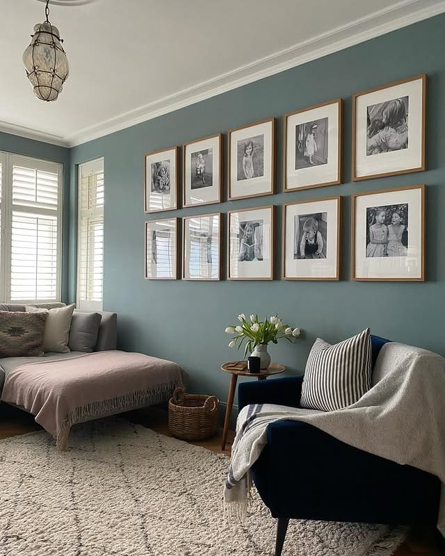 16. Symmetrical Photo Gallery Wall in Muted Blue - gallery wall living room ideas