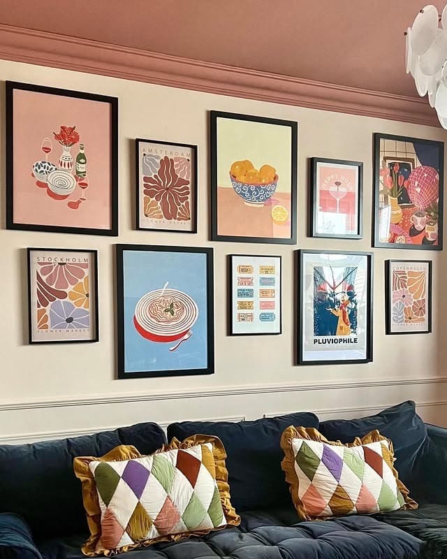 20. Graphic Poster Gallery Wall with Warm Pastels and Black Frames - gallery wall living room ideas