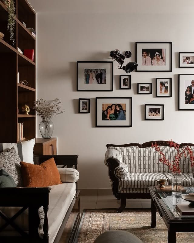 22. Personal Photo Gallery Wall with Warm Browns and Black - gallery wall living room ideas