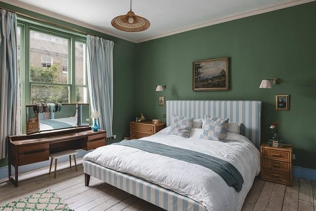 4. Deep Green Walls with Soft Blue Upholstery - blue and green bedroom ideas