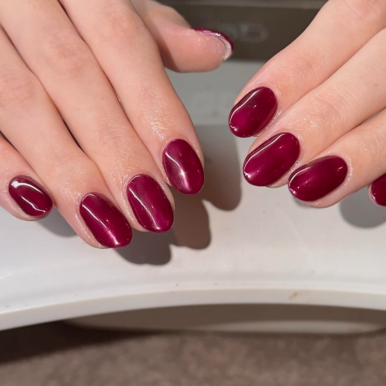 13. Wine Red Chrome Oval Manicure - red chrome nail ideas