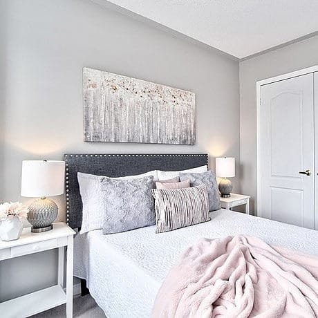 16. Modern Gray Bedroom with Blush Layered Textiles - pink and gray bedroom ideas