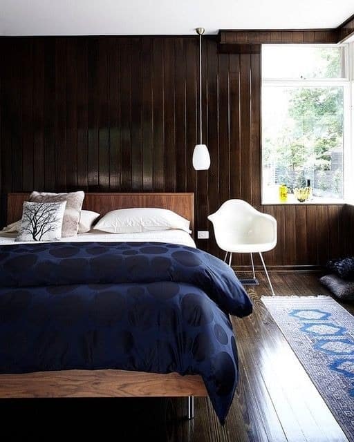 22. Classic Dark Wood Bedroom with Navy and Natural Light - dark wood bedroom ideas