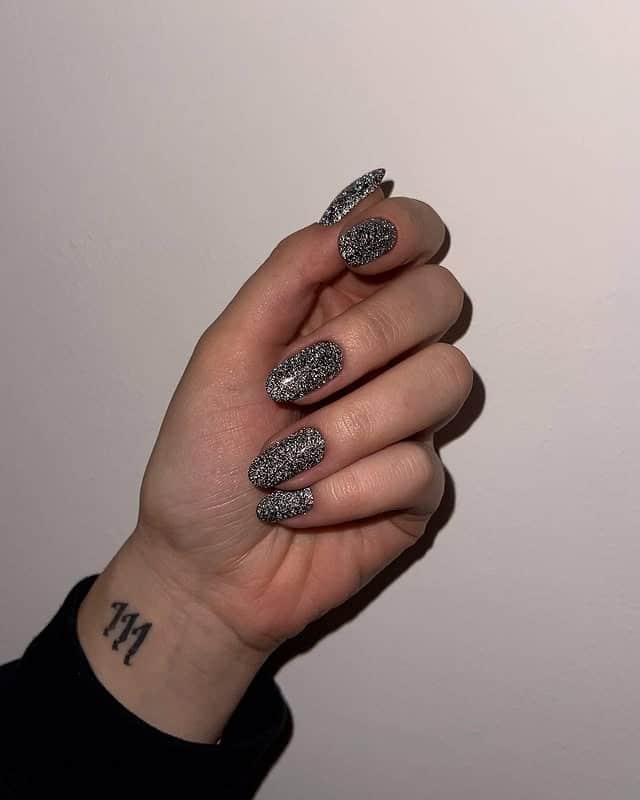 7. Full-Cover Silver Glitter Almond Nails - silver glitter nail ideas