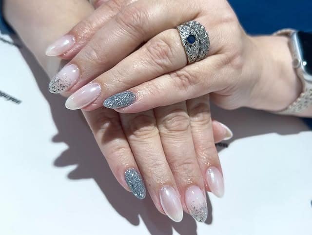 14. Soft Almond Nails with Silver Glitter Accents - silver glitter nail ideas
