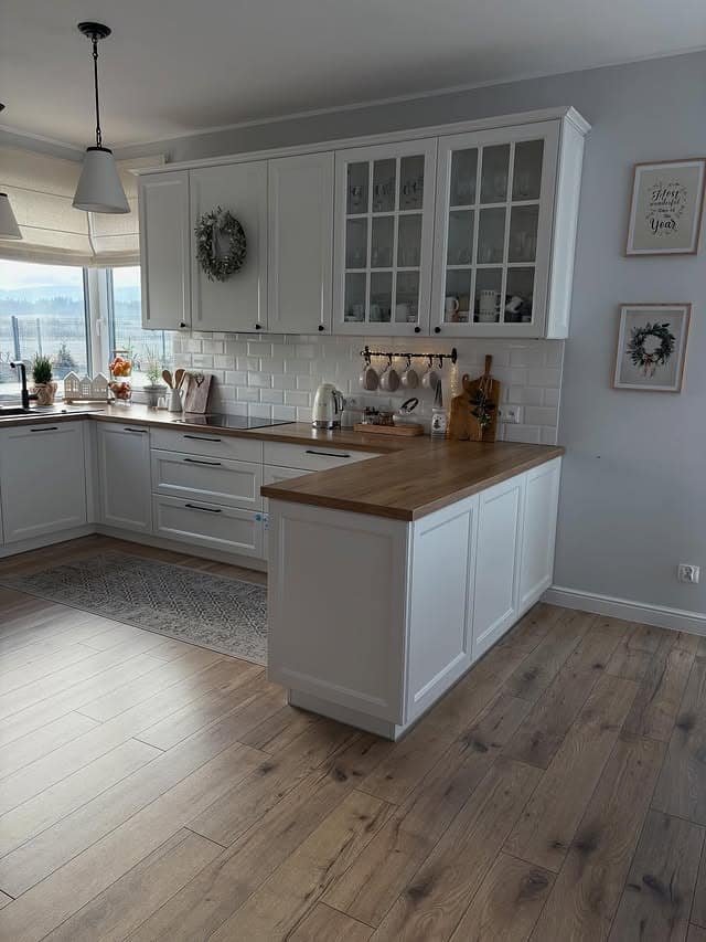 4. Classic White Kitchen with Wood Counters and Subtle Contrast - small cozy kitchen ideas
