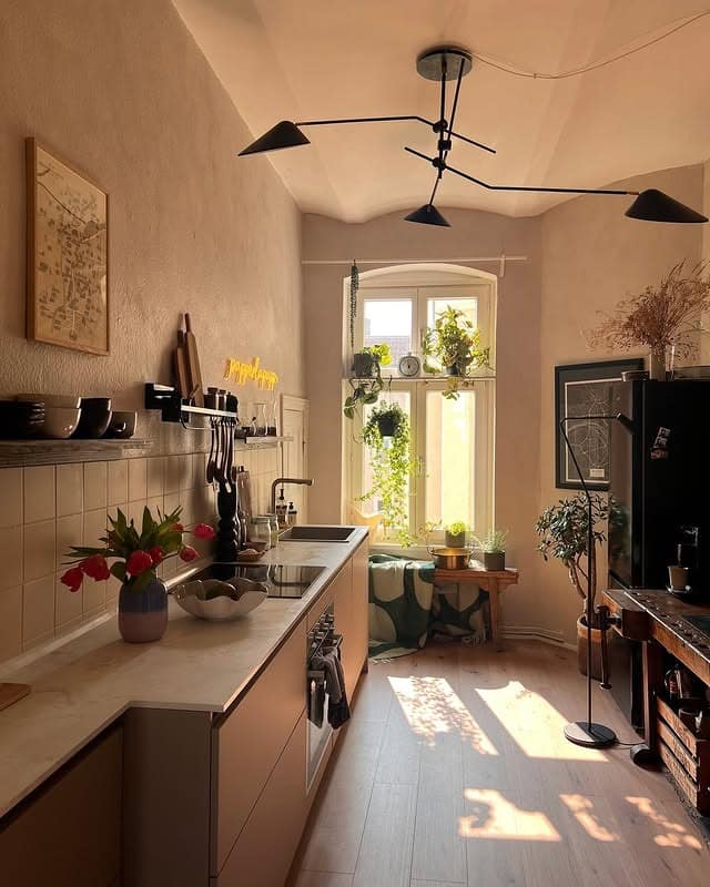 6. Compact Modern Kitchen with Soft Beige and Black Details - small cozy kitchen ideas
