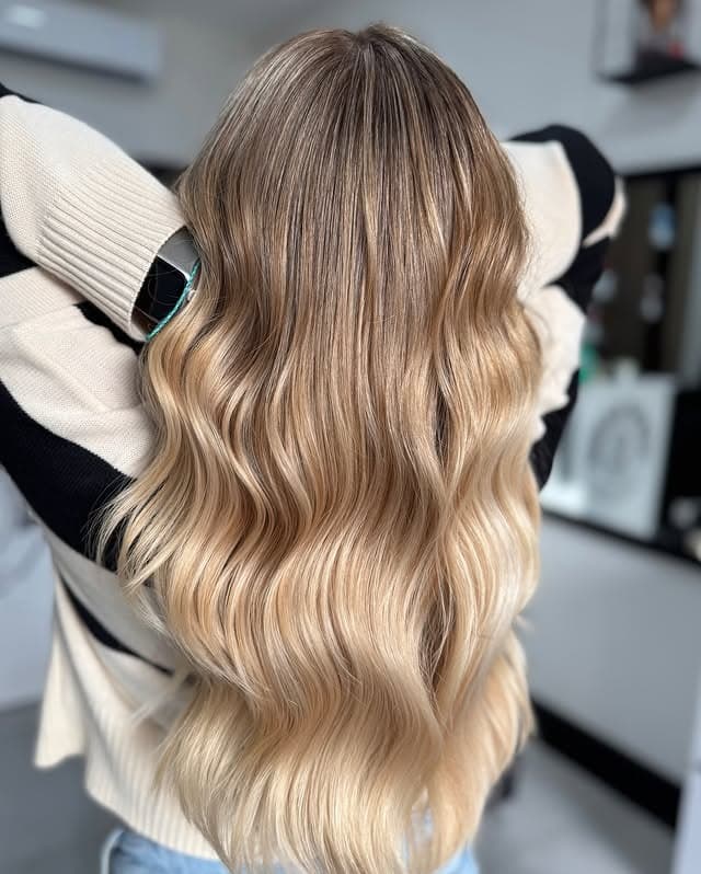 11. Soft Rooted Blonde with Long Flowing Waves - Blonde Hair Color