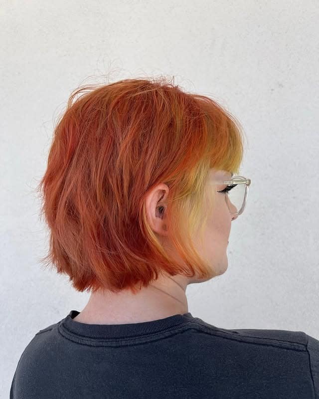 9. Sunset Copper Shaggy Bob with Micro Bangs - Shaggy Bob Hairstyles