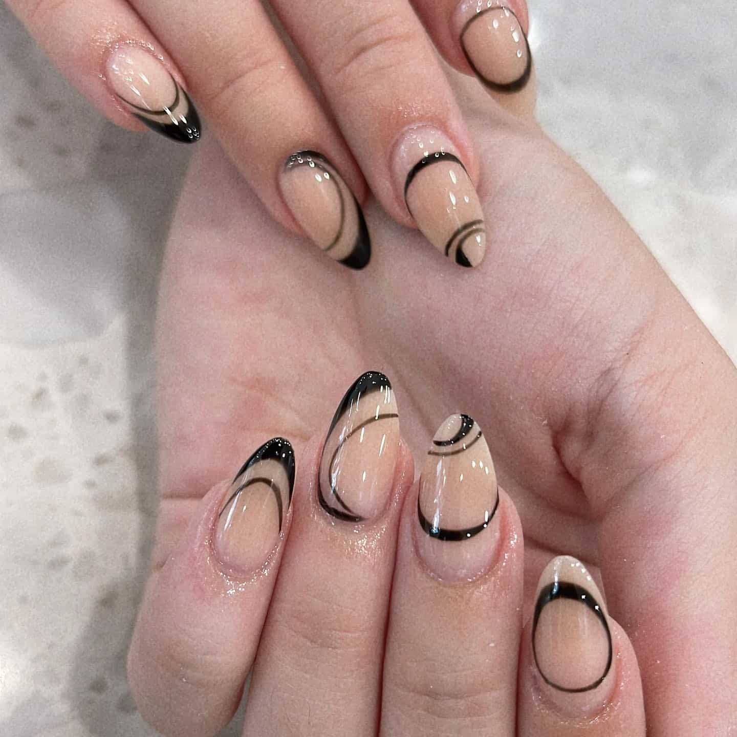 11. Almond Nude Nails with Black Outline Line Art - simple line nail ideas