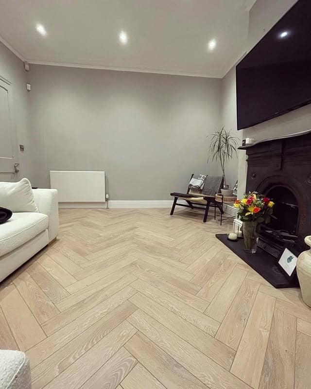 4. Contemporary Neutral Living Room with Chevron Wood Floors - living room floor ideas