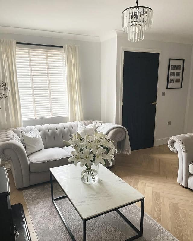 9. Timeless Living Room with Blonde Wood Herringbone Floors - living room floor ideas