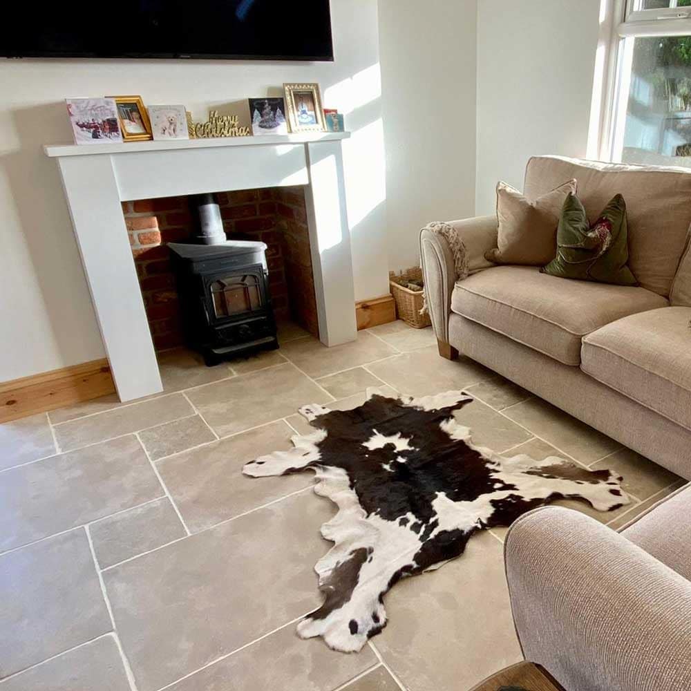 10. Country-Style Living Room with Natural Stone Tile Floors - living room floor ideas