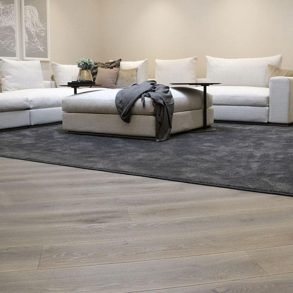 12. Charcoal Area Rug Over Grey Wood Flooring - living room floor ideas
