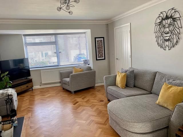 18. Classic Parquet Flooring with Soft Neutral Accents - living room floor ideas