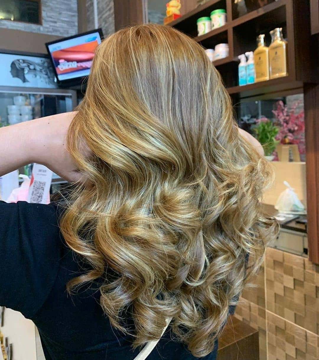 5. Glossy Light Brown Curls with Golden Highlights - Light Brown Hair with Highlights