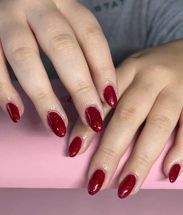 14. Short Red Sparkle Oval Nails - sparkly red nail ideas