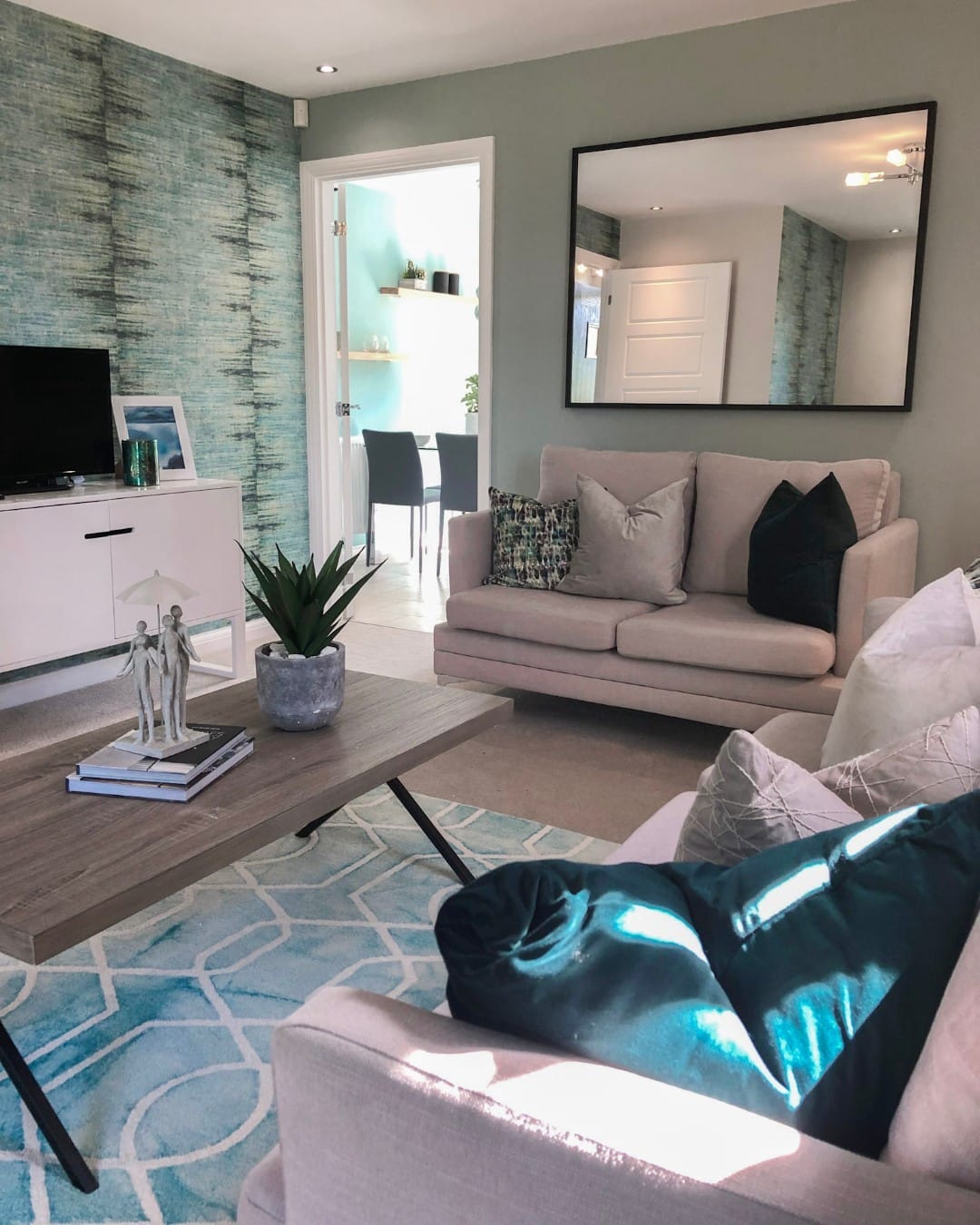 13. Soft Blue and Grey Living Room with Textured Accent Wall - blue and grey living room ideas