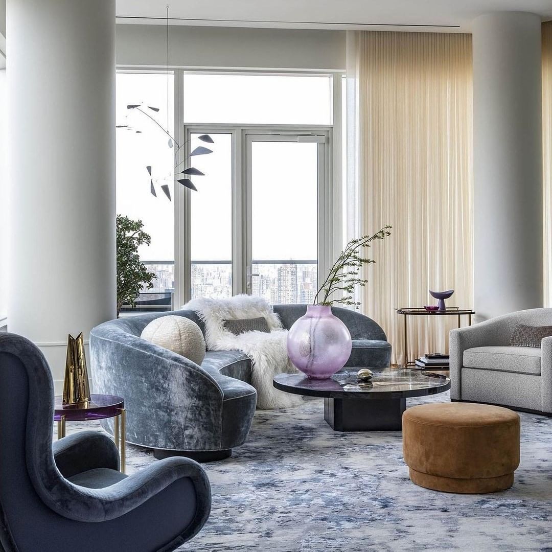 14. Curved Grey Seating in a Blue-Toned Urban Living Room - blue and grey living room ideas