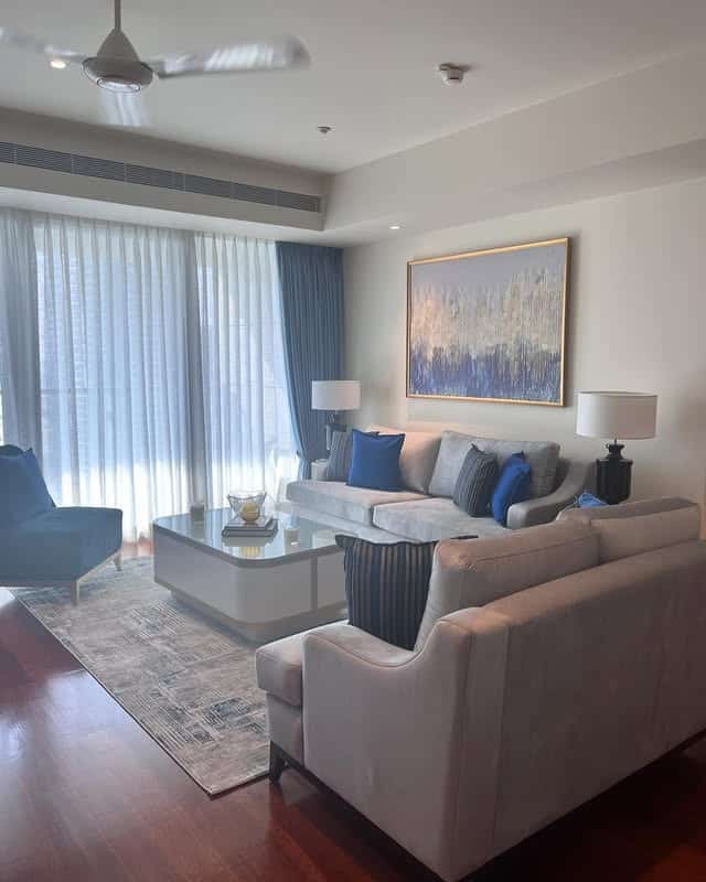 15. Neutral Grey Living Room with Blue Artwork Accents - blue and grey living room ideas