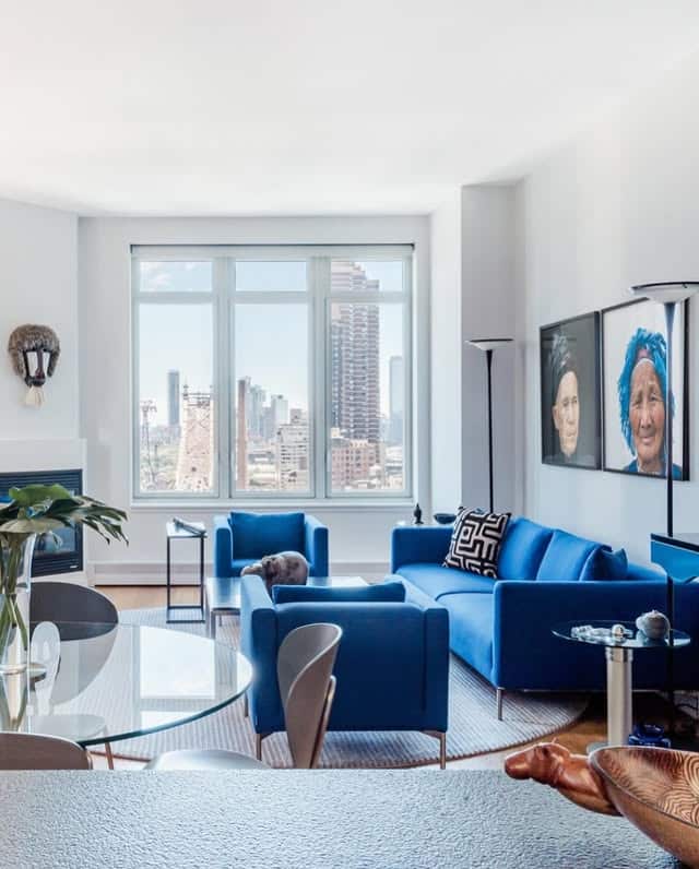 16. City Living Room with Bold Blue Seating and Soft Grey Walls - blue and grey living room ideas