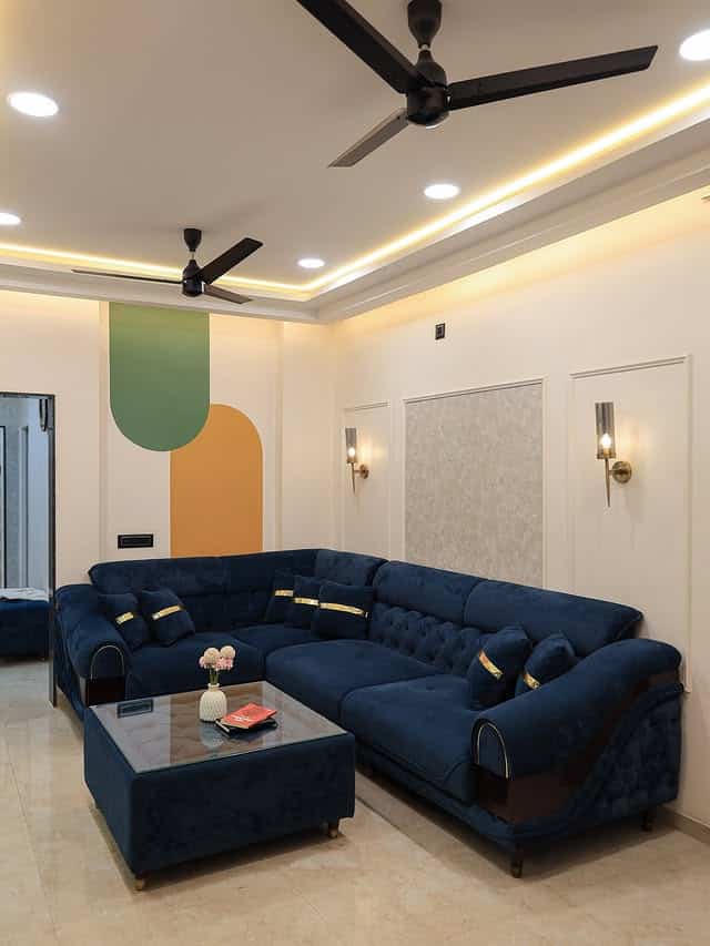 20. Modern Blue Sectional with Soft Grey Architectural Details - blue and grey living room ideas