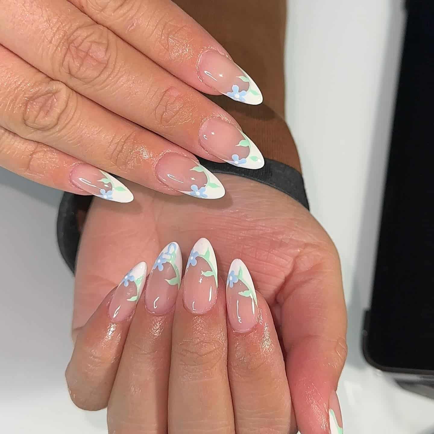 16. White Floral French Tips with Green Accents - spring french tip nail ideas