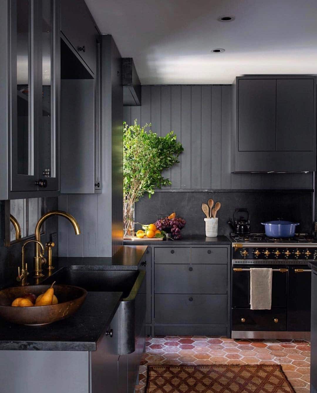 2. Moody Charcoal Kitchen with Brass and Stone Details - black kitchen ideas