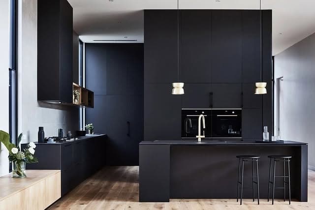 3. Minimal Black Kitchen with Architectural Precision - black kitchen ideas