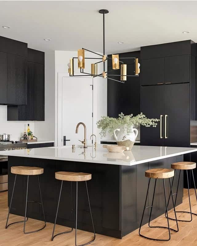 4. Black Kitchen with White Quartz Island and Graphic Lighting - black kitchen ideas