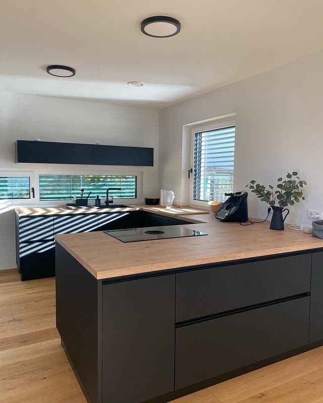 15. Black and Wood Kitchen with Natural Light - black kitchen ideas