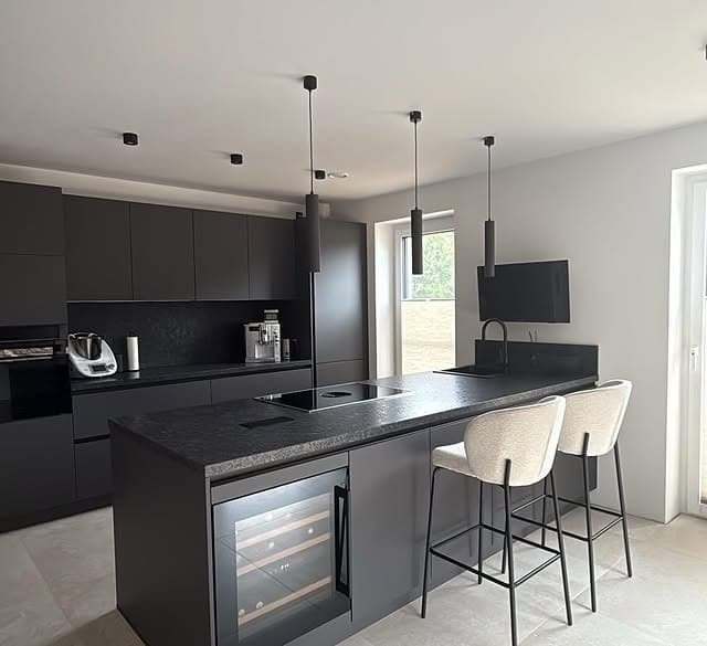 18. Black Kitchen with Bar Seating and Built-In Storage - black kitchen ideas