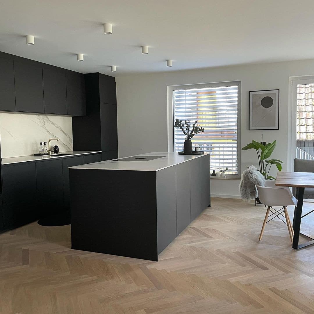 20. Contemporary Black Kitchen with Soft Wood Flooring - black kitchen ideas