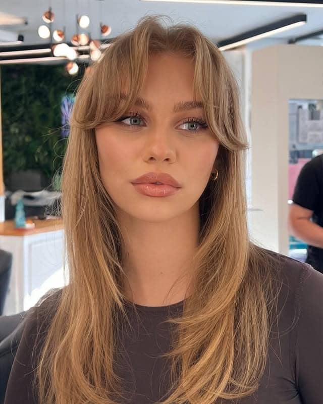 8. Long Wavy Layers with Full Bangs in Golden Blonde - Wavy Hair with Bangs