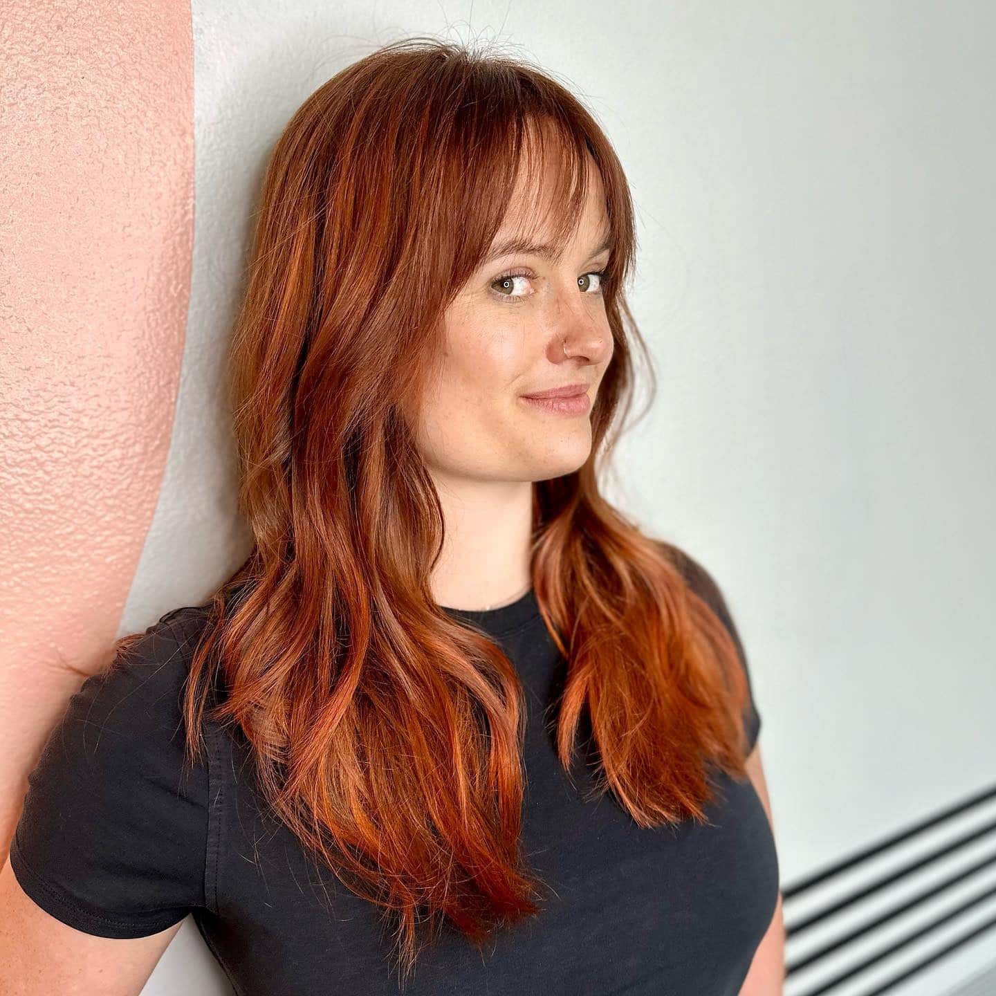 18. Copper-Toned Wavy Layers with Light Fringe - Wavy Hair with Bangs