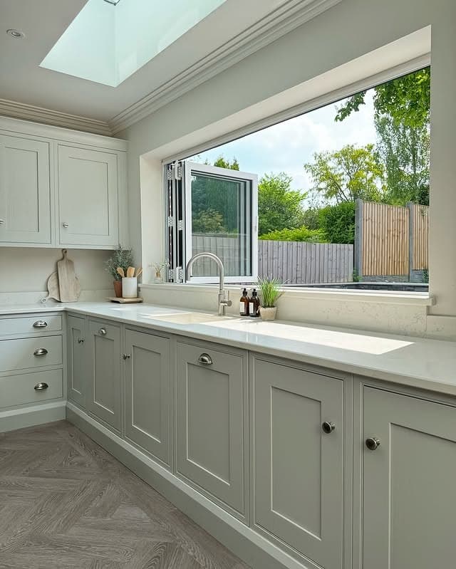 8. Skylit Kitchen with Soft Gray Cabinetry - kitchen window ideas