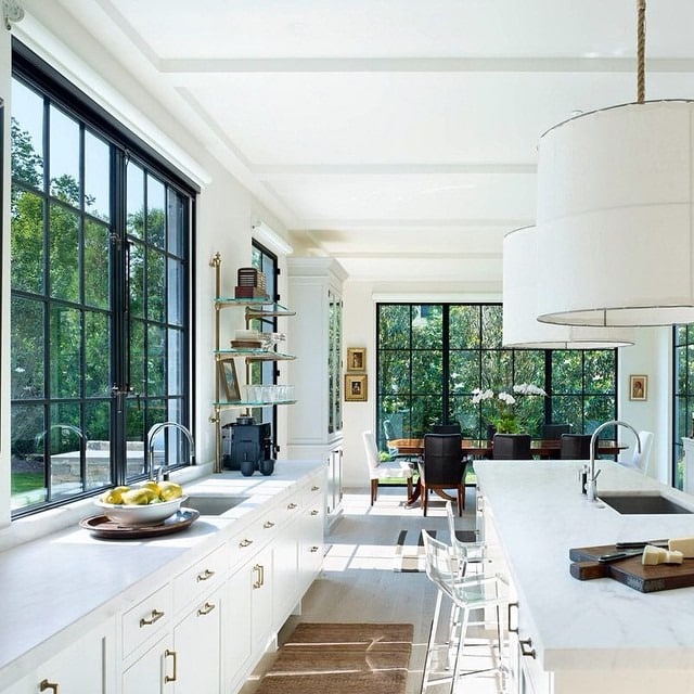12. White Kitchen with Black-Framed Windows - kitchen window ideas