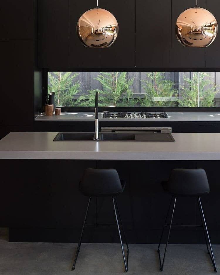 17. Lush Kitchen Window with Layered Greenery - kitchen window ideas