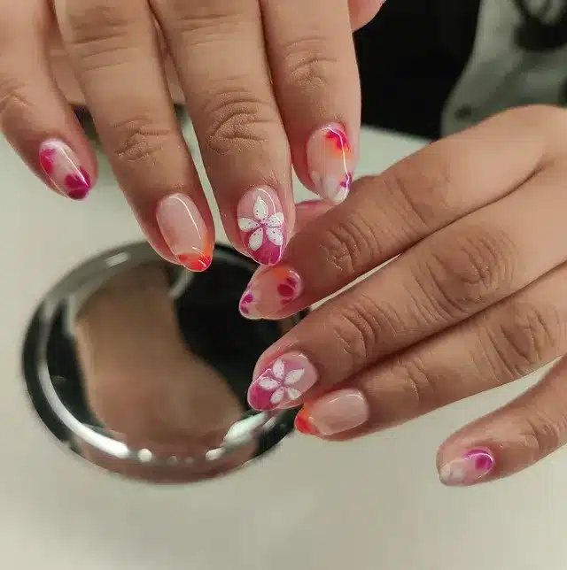 2. Soft Tropical Bloom Almond Nails in Blush Pink and Coral - tropical flower nail ideas