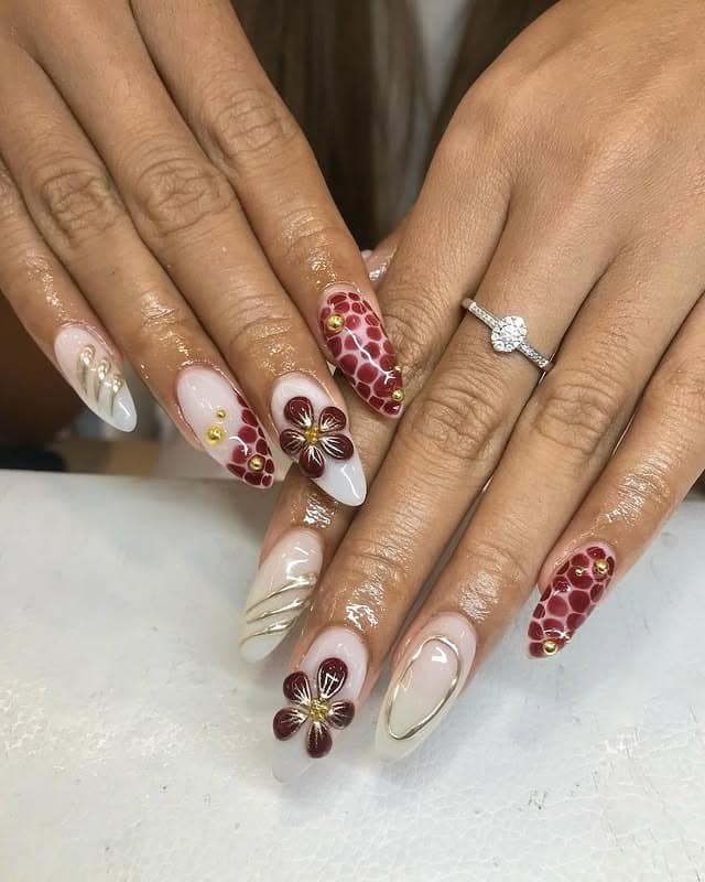 13. Elegant Tropical Flower Almond Nails in Nude and Burgundy - tropical flower nail ideas