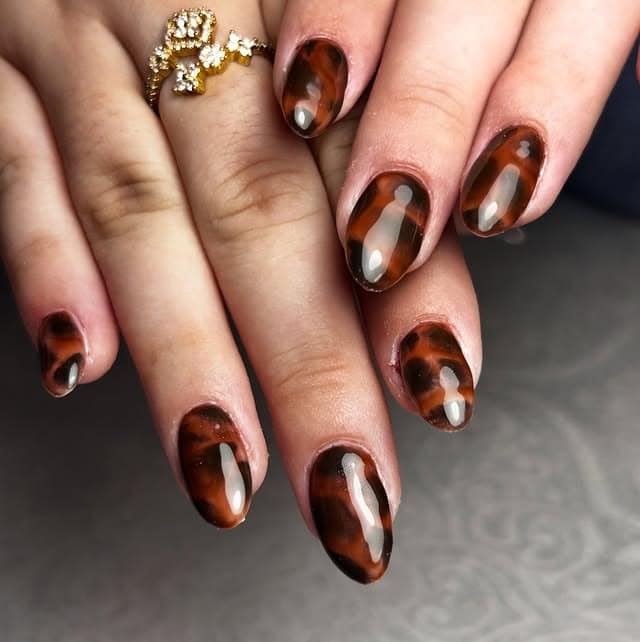 2. Classic Oval Tortoiseshell Nails in Deep Brown - turtle nail ideas