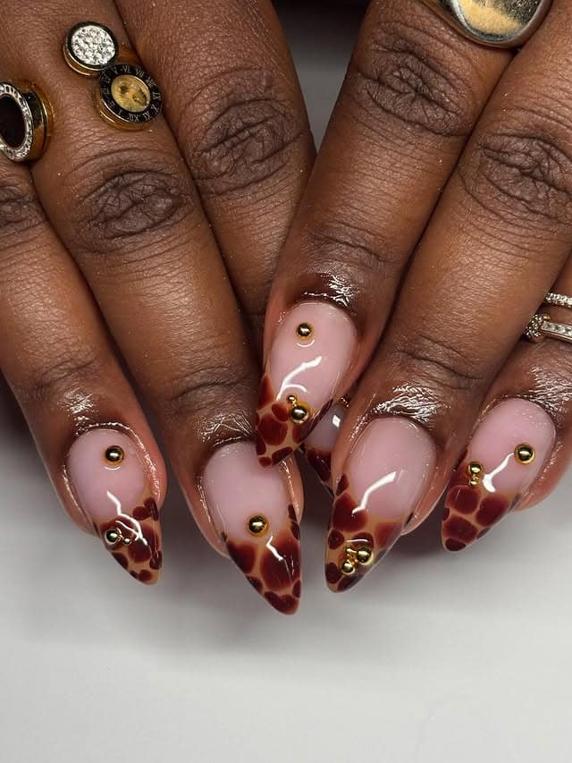 7. Nude Almond Nails with Tortoiseshell and Gold Stud Details - turtle nail ideas