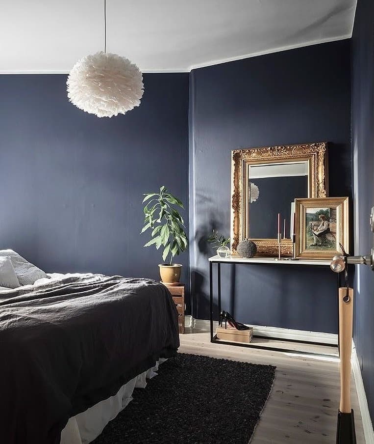 21. Classic Dark Blue Bedroom with Antique Accents - dark blue bedroom ideas