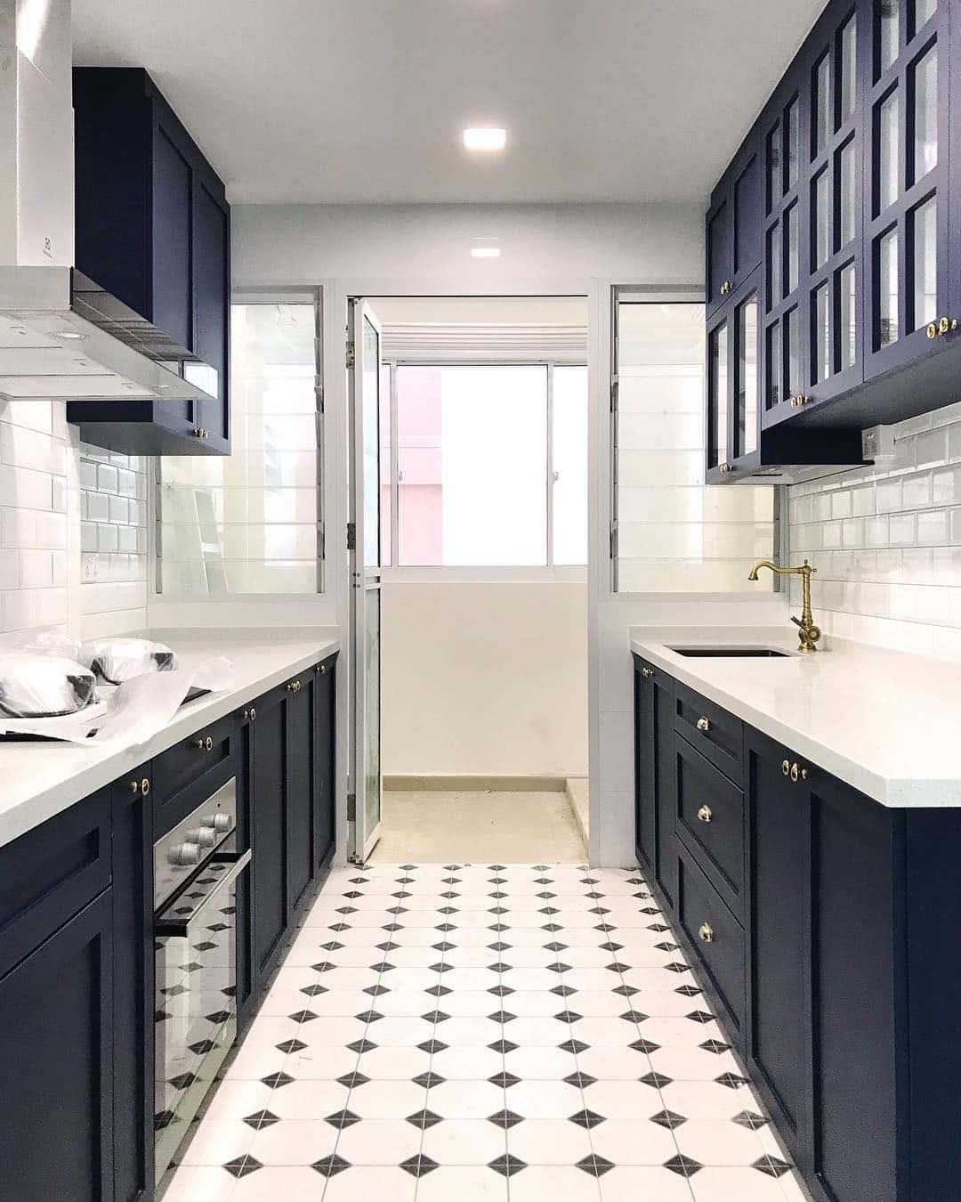 21. Navy Victorian Galley Kitchen with Brass Details - victorian style kitchen ideas